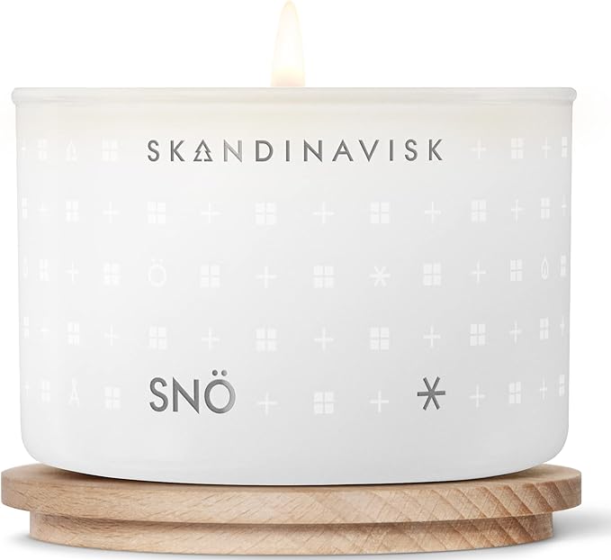 Skandinavisk SNÖ 'Snow' Scented Candle. Fragrance Notes: Frozen Forests and Frosted Berries, The Sharp Breath of Subzero Skies. 3.17 oz.