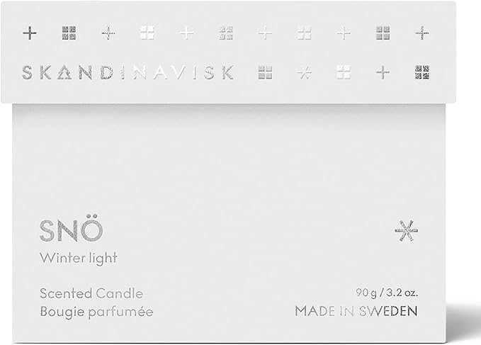 Skandinavisk SNÖ 'Snow' Scented Candle. Fragrance Notes: Frozen Forests and Frosted Berries, The Sharp Breath of Subzero Skies. 3.17 oz.