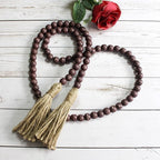 CVHOMEDECO. Wood Beads Garland with Tassels Farmhouse Rustic Wooden Prayer Bead String Wall Hanging Accent for Home Festival Decor. Brown Distressed