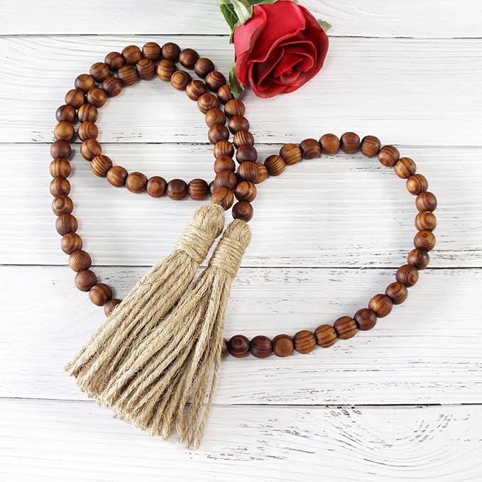 CVHOMEDECO. Wood Grain Beads Garland with Tassels Farmhouse Rustic Wooden Prayer Bead String Wall Hanging Accent for Home Festival Decor. Dark Tan