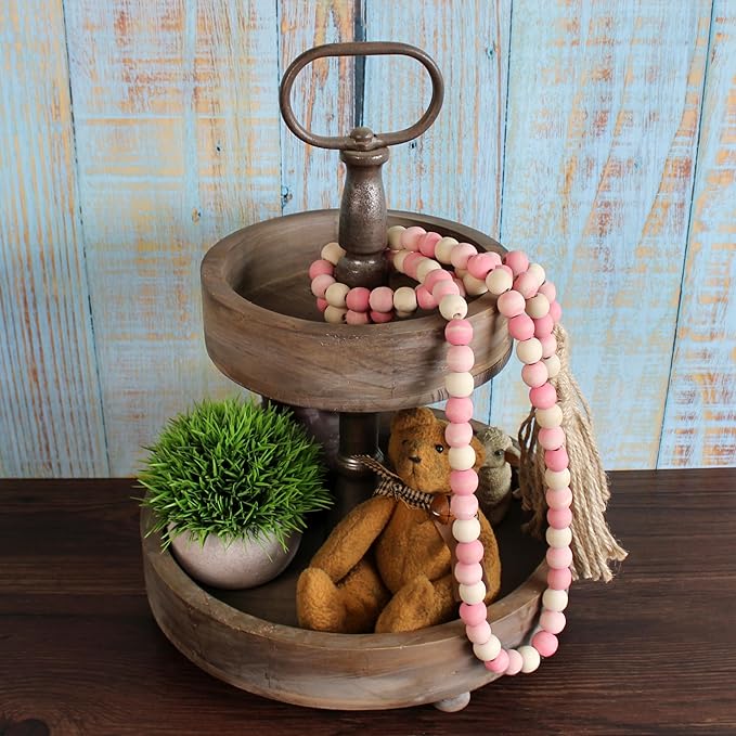 CVHOMEDECO. Wood Beads Garland with Tassels Farmhouse Rustic Wooden Prayer Bead String Wall Hanging Accent for Home Festival Decor. Pink Mix Distressed