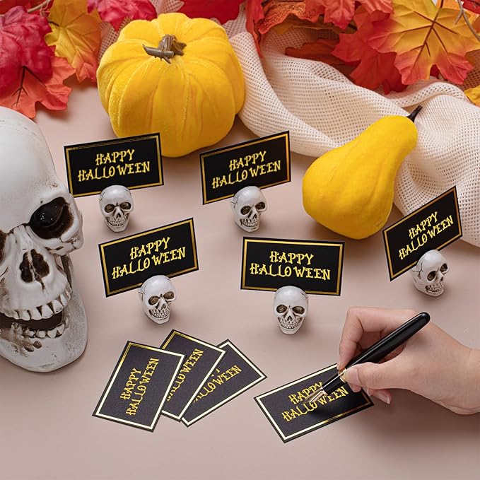 24 Set Halloween Skull Place Card Holders with 48 Pcs Place Cards Resin Small Skull Head Table Number Holders Clips Photo Stand Centerpieces for Halloween Party Wedding Birthday Decorations