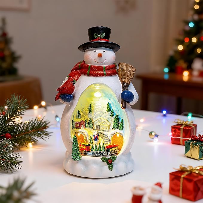 Snowman Figurine Lighted Christmas Village with Animated Rotating Train - Battery or USB Powered Snowman Decor Ornaments, LED Lights & Festive Music for Tabletop Home Holiday Collection Decorations