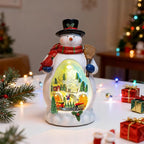Snowman Figurine Lighted Christmas Village with Animated Rotating Train - Battery or USB Powered Snowman Decor Ornaments, LED Lights & Festive Music for Tabletop Home Holiday Collection Decorations