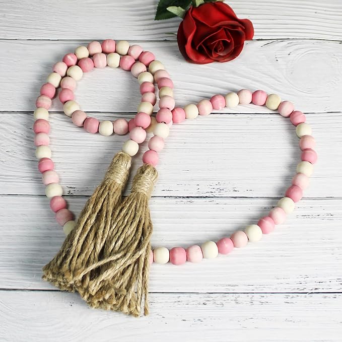 CVHOMEDECO. Wood Beads Garland with Tassels Farmhouse Rustic Wooden Prayer Bead String Wall Hanging Accent for Home Festival Decor. Pink Mix Distressed