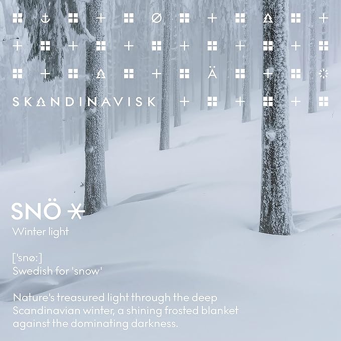 Skandinavisk SNÖ 'Snow' Scented Candle. Fragrance Notes: Frozen Forests and Frosted Berries, The Sharp Breath of Subzero Skies. 3.17 oz.