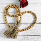 CVHOMEDECO. Wood Grain Beads Garland with Tassels Farmhouse Rustic Wooden Prayer Bead String Wall Hanging Accent for Home Festival Decor. Light Tan